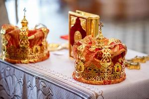 golden crown of newlyweds in the church photo