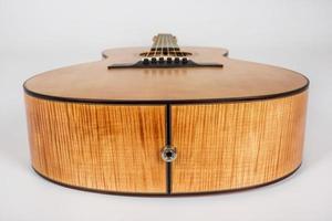 wood texture of lower deck of six strings acoustic guitar on white background. guitar shape photo