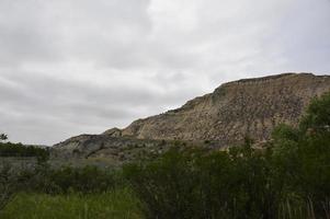 Sandstone Hillside with Large Hill Into a Canyon photo
