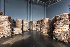 Paper pressed bales at the modern waste hazardous processing plant. Separate garbage collection. Recycling and storage of waste for further disposal. Business for sorting and processing of waste. photo