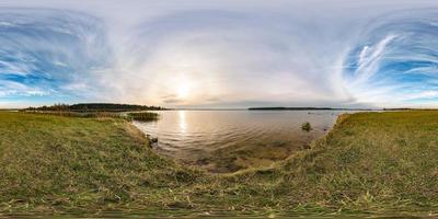 vista de ángulo de 360 grados de panorama hdri esférico sin costuras en la costa de hierba de un río o lago enorme en un día soleado de verano y clima ventoso en proyección equirectangular con cenit y nadir, contenido vr ar foto