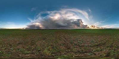full seamless spherical hdr panorama 360 degrees angle view among fields with awesome black clouds before storm in equirectangular projection, VR AR virtual reality content with zenith photo