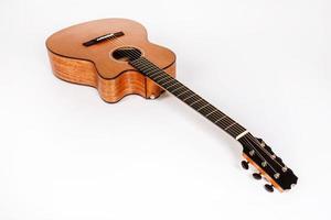 wood texture of lower deck of six strings acoustic guitar on white background. guitar shape photo