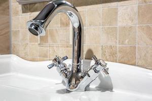 Water tap sink with faucet in expensive loft bathroom photo