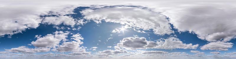 Seamless hdri panorama 360 degrees angle view blue sky with beautiful fluffy cumulus clouds without ground with zenith for use in 3d graphics or game development as sky dome or edit drone shot photo