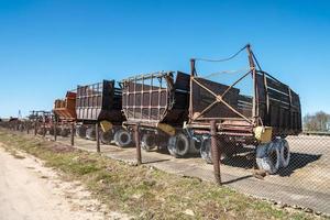 Parking agricultural machinery and harvest. rows of plows, cultivators, bodies photo