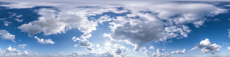 Seamless hdri panorama 360 degrees angle view blue sky with beautiful fluffy cumulus clouds with zenith for use in 3d graphics or game development as sky dome or edit drone shot photo