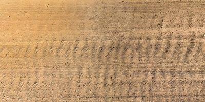 view from above on texture of gravel road with car tire tracks photo