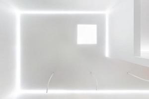 looking up on suspended ceiling with halogen spots lamps and drywall construction in empty room in apartment or house. Stretch ceiling white and complex shape. photo