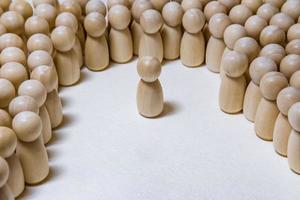 follow the leader or human resource management concept. crowd of wooden people photo