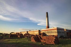 Brickfield View of the Evening Sunlight under the White Cloudy Blue sky photo