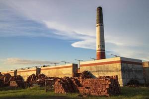 Brickfield View of the Evening Sunlight under the White Cloudy Blue sky photo