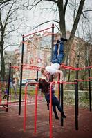 Stylish couple wear on checkered shirt in love together kissing on bars workout. photo