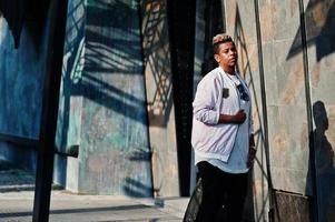 Stylish hipster arab man guy posed outdoor in street. Style rap singer. photo