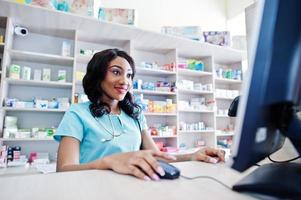 African american pharmacist cashier working in drugstore at hospital pharmacy. African healthcare. photo