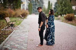 Love story of indian couple posed outdoor. photo