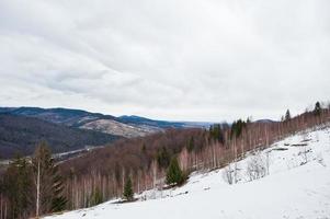 Snowy mountain valleys at Carpathian mountains. View of Ukrainian Carpathians and Yaremche from the top of Makovitsa. photo