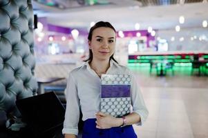 Waiter girl holding menu at cafe. People and service concept photo