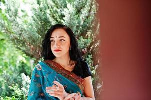 Portrait of beautiful indian brumette girl or hindu woman model. Traditional Indian costume lehenga choli. photo