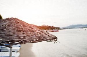 Bamboo and reed straw beach umbrellas photo