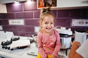 Kids cooking at kitchen, happy children's moments. photo