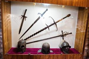 Medieval weapons or tools behind the glass in the museum. photo
