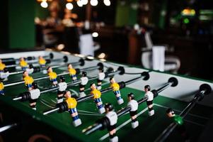 Table football or soccer game with yellow and white players. photo