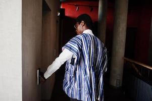 African american man at elavator or modern lift, pushing button. photo