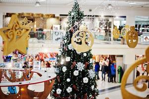 New Year decorations in shopping mall with Christmas tree. photo