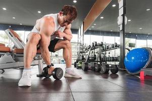 Asian men exercise by lifting weights or lifting dumbbells. Asian bodybuilder fitness concept photo