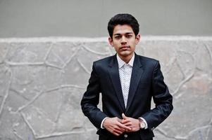 Young indian man on suit posed outdoor. photo