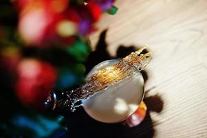 Alcoholic cocktail with fused sugar in bronze glass on bar table. photo