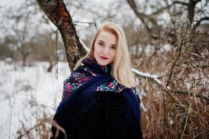 Blonde girl with hand embroidered scarf posed at winter day. Women's handkerchief. photo