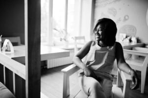 Stylish african american girl posed at modern cafe. photo