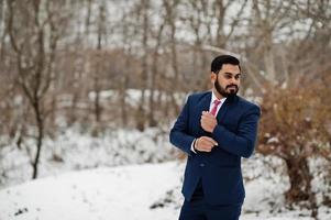 Stylish indian beard business man in suit posed at winter day outdoor. photo