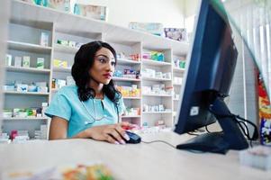 African american pharmacist cashier working in drugstore at hospital pharmacy. African healthcare. photo