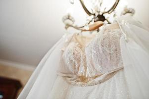 Wedding dress hanging ceiling. Bride day. photo