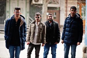 Group of four indian ethnicity friendship togetherness mans at jackets. Cold weather in India. photo