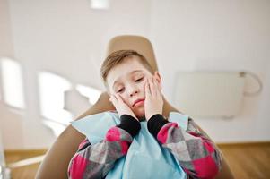 Little boy at dentist chair. Children dental. photo