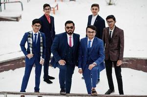 Group of six indian businessman in suits posed outdoor in winter day at Europe. photo