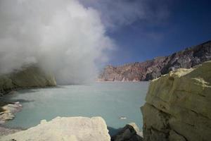 Sulfur mine with workers in Kawah Ijen, Java, Indonesia photo