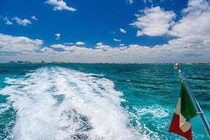 Mexican flag on ship boat ferry in Caribbean Ocean near Cancun, photo