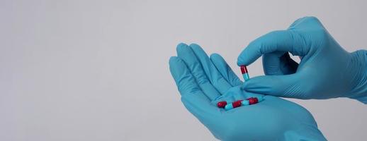 Taking or holding medication pills in hand. Capsule pill on white background. photo