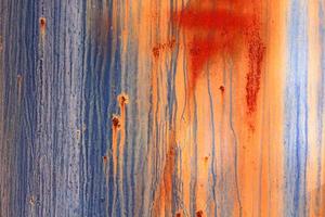 A rotted metal panel covered in rust photo