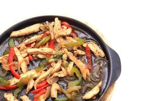 Hot skillet of chicken fajitas and vegetables photo