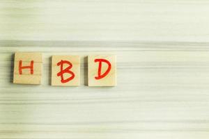 alphabet on small plate on wood table for happy birthday image. photo