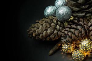 The christmas ball and Pine cones  on black  background. photo