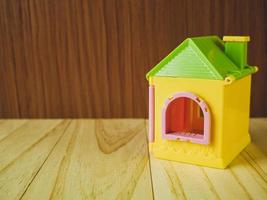 The home toy on wood table for property and building content. photo