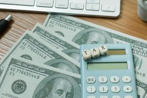 Tax wooden cubic on work table for business content. photo