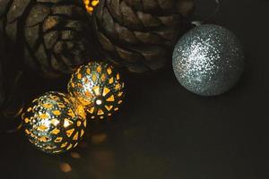 The christmas ball and Pine cones  on black  background. photo